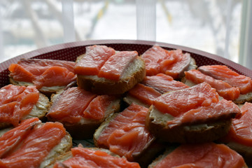 Sandwiches with butter and red fish. Salmon fillet. Festive snacks on the table.