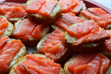 Sandwiches with butter and red fish. Salmon fillet. Festive snacks on the table.