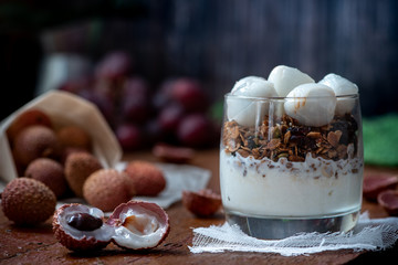 Healthy breakfast. Granola, lychee and yogurt in a glass. Parfait