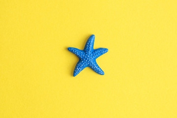 Flat lay of star fish on yellow abstract. Space for copy.