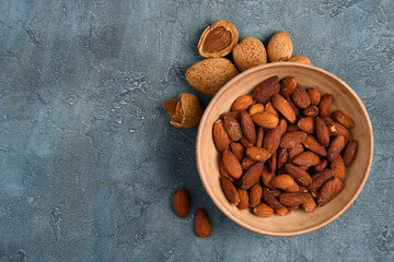 Almond roasted and salted in the bowl on rustic table