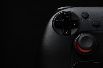Dark game pad video game controller joy stick on black background with copy space © nevodka.com