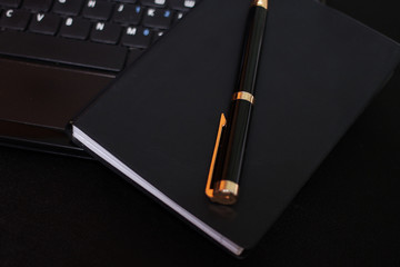 notebook, pen and laptop