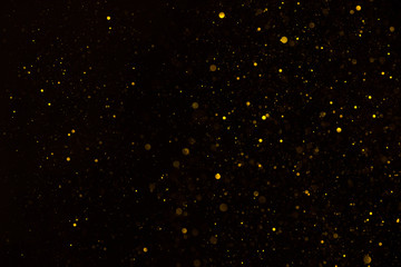 Glitter particles shiny star dust fall on black background