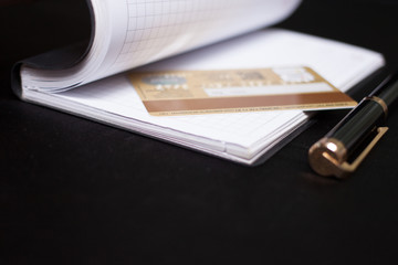 Notepad, pen and credit card.