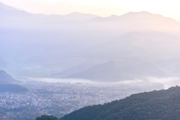 Naklejka premium Foggy Sunrise Over the Himalayas Mountain Range from Sarangkot Hill