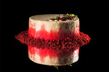 Obraz na płótnie Canvas white cake decorated with red currants and mint leaves isolated on black