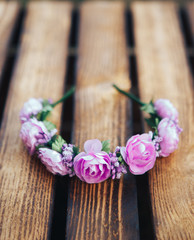 Handmade hoop purple flowers. Red and white hair band on wooden background