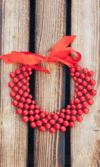 Fototapeta na wymiar Red beads handmade. Wooden background. Top view. Ukrainian style