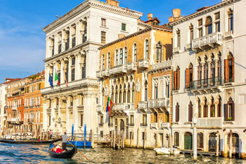 Naklejka premium Gondolier in Venice near old Venerian palaces of Grand Canal