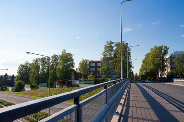 Bridge over the motorway in the residential area of the city of Helsinki in Finland on a summer day.