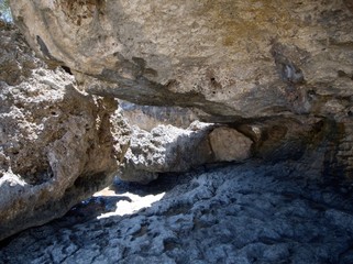 Close up of the big rocks forming a cave-like structure at a beach on Saipan