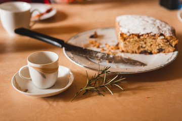 Fototapeta premium Close-up of cup of coffee and amaretto cake wit rosemary branch