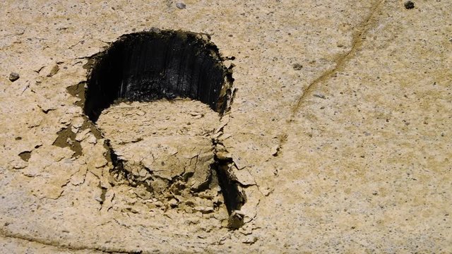 Oil under a cracked footprint in the Great Salt Desert, Dash-e Kavir in Iran.
