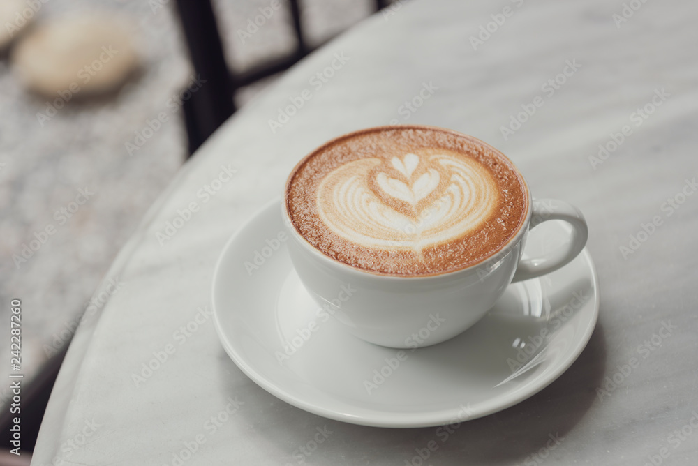 Wall mural latte or cappuccino with frothy foam, coffee cup top view on table in cafe.