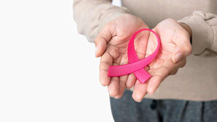 Woman holding pink ribbon. supporting symbol of breast cancer awareness and international women day campaign.