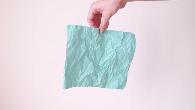 Crumpled colorful paper in male hand