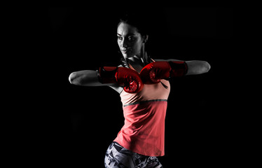 Sport woman on dark background with boxing gloves