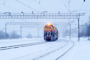 railway snow machine at the station during snowfall
