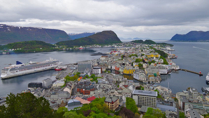 Modern Costa cruiseship cruise ship liner in Alesund, Norway on sunny day with breathtaking nature...