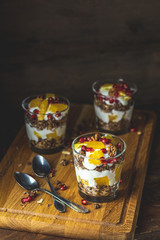 Greek yogurt with granola, orange and pomegranate berries