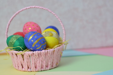 Easter, Easter egg color vibrant, spring Orthodox holiday. colorful decorated eggs in a pink basket on a background of different colors
