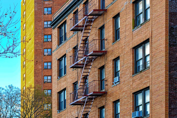 New-York building facades with fire escape stairs angle view