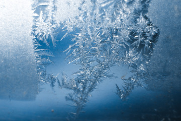 Fototapeta premium Frosty patterns on the frozen window are macro. Winter background
