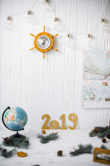 Globe on white wooden background with barometer