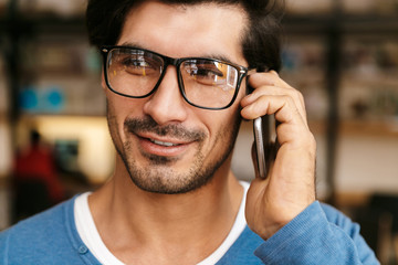 Close up of a handsome young man wearing sunglasses