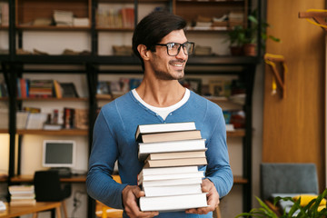 Handsome young man wearing glasses standing
