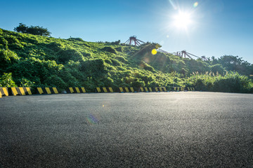 Empty parking lot with forest and beautiful blue sky. © evening_tao