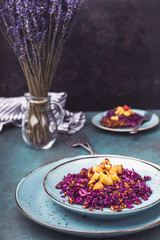 Red cabbage salad with fried apples caramelized with cinnamon