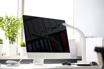 Empty silver pc screen at desktop against window
