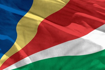 Waving Seychelles flag for using as texture or background, the flag is fluttering on the wind