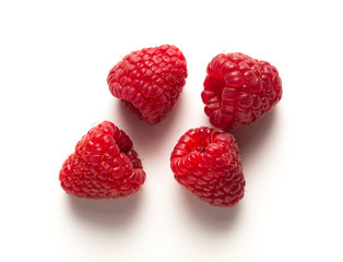 four raspberries on white table, with shadow
