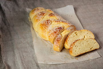 Sliced challah jewish bread served with cottage cheese on linen cloth