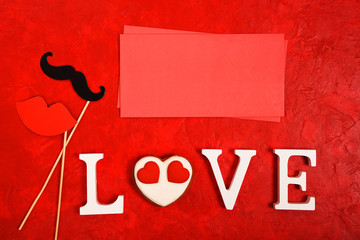 The word Love and a heart on a bright red background. view from above. Place for text

