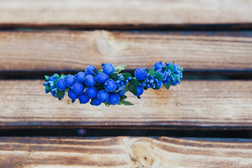 Handmade hoop blue flowers. Blue hair band on wooden background. Top view