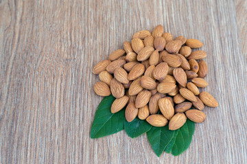 Almond nut on wood background.