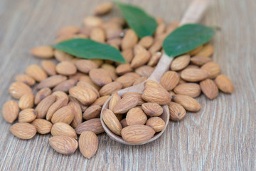 Almond nut on wood background.