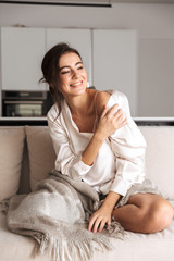 Attractive young woman sitting on a couch