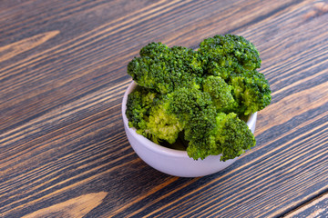 Bowl of cooked green broccoli.