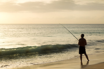 Man fishing on a beach