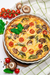 Baked homemade quiche pie in ceramic baking form
