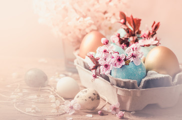 Easter eggs and spring flowers on rustic wooden background.Easter holiday card copy space.