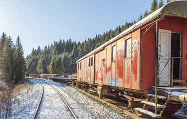 Obraz premium Train. Rusty. Snow. Winter. Forest. Hills