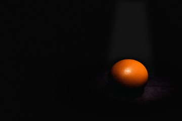Raw eggs on dark background