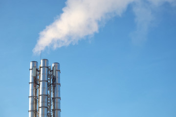 smoke from the pipes against the blue sky