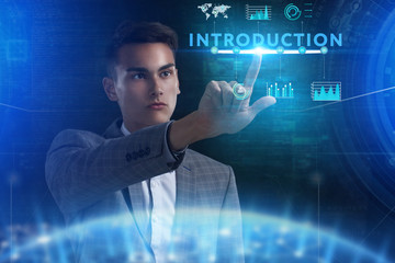 The concept of business, technology, the Internet and the network. A young entrepreneur working on a virtual screen of the future and sees the inscription: introduction